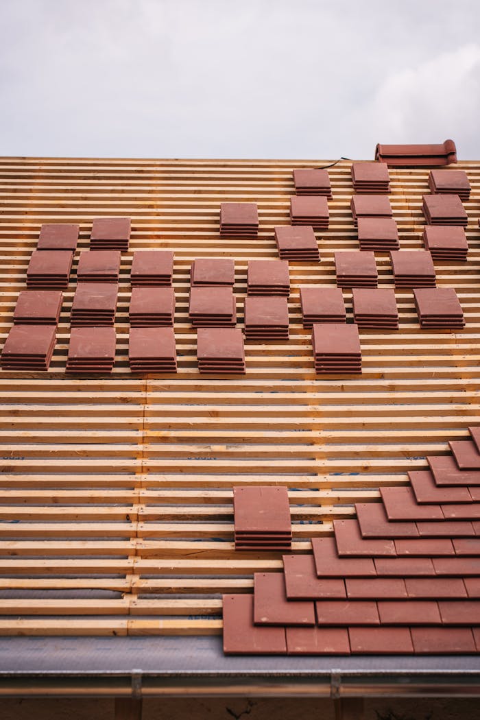 why-choose-us View of a roof under construction with red tiles and wooden lattice framework, showcasing modern architecture techniques.